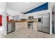 Modern kitchen with stainless steel appliances, granite countertops, and white cabinetry at 622 Parakeet Ct, Kissimmee, FL 34759