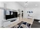 Spacious living room with entertainment center, view to kitchen, and tiled floor at 622 Parakeet Ct, Kissimmee, FL 34759