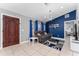 Inviting living room with blue accent wall, stylish chandelier, and comfortable seating at 622 Parakeet Ct, Kissimmee, FL 34759