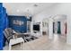 Open-concept living room with blue accent wall and view of adjacent rooms at 622 Parakeet Ct, Kissimmee, FL 34759