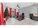 Living room with two red gaming chairs, a TV, and a Christmas tree at 622 Parakeet Ct, Kissimmee, FL 34759