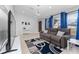 Living area with large TV, gray sofa, and blue curtains, creating a cozy atmosphere at 622 Parakeet Ct, Kissimmee, FL 34759