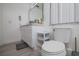 Clean and modern bathroom with white vanity, toilet, and gray flooring at 733 Calabria Ave, Davenport, FL 33897