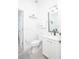 White modern bathroom with sleek fixtures, vanity, and toilet at 733 Calabria Ave, Davenport, FL 33897
