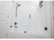 White tile shower with glass door and black hardware inside a bright bathroom at 733 Calabria Ave, Davenport, FL 33897