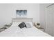 Tranquil bedroom featuring a white-dressed bed, soft pillows, and minimalist artwork at 733 Calabria Ave, Davenport, FL 33897