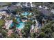 Large community pool with slides, lounge chairs, and tropical landscaping at 733 Calabria Ave, Davenport, FL 33897