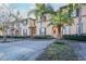 Townhome with palm trees, landscaping, and a brick walkway at 733 Calabria Ave, Davenport, FL 33897