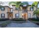 Attractive townhome exterior with palm trees and landscaping at 733 Calabria Ave, Davenport, FL 33897