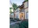 Townhome entrance with balcony, palm trees, and landscaping at 733 Calabria Ave, Davenport, FL 33897