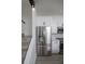 Close-up view of the stainless steel refrigerator and white cabinets in the kitchen at 733 Calabria Ave, Davenport, FL 33897