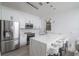 Contemporary kitchen with stainless steel appliances, white cabinets, and a quartz island with seating at 733 Calabria Ave, Davenport, FL 33897