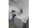 Stylish kitchen with white cabinetry, marble countertops, and a large island with bar seating at 733 Calabria Ave, Davenport, FL 33897