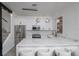 Bright, updated kitchen featuring white shaker cabinets, a quartz waterfall island, and stainless steel appliances at 733 Calabria Ave, Davenport, FL 33897