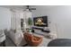 Living room with light-colored walls, white drapes, a brown leather chair, and light wood-look flooring at 733 Calabria Ave, Davenport, FL 33897