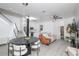 Living and dining room with ceiling fan, modern light fixtures, white marble kitchen island, and wood-look floor at 733 Calabria Ave, Davenport, FL 33897