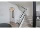 Modern staircase with glass railing and wood-look tile flooring at 733 Calabria Ave, Davenport, FL 33897