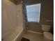 Bathroom with shower/tub combo and window at 842 Sussex Dr, Davenport, FL 33896