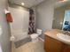 Clean bathroom with tub shower, toilet and vanity at 842 Sussex Dr, Davenport, FL 33896