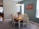 Bright dining room with a table set for six at 842 Sussex Dr, Davenport, FL 33896