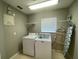 Laundry room with washer, dryer and shelving at 842 Sussex Dr, Davenport, FL 33896