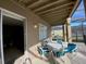 Covered patio with table and chairs, adjacent to the house at 842 Sussex Dr, Davenport, FL 33896