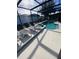 Inviting pool area with screened enclosure, lounge chairs, and spa at 842 Sussex Dr, Davenport, FL 33896