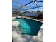 Inviting screened-in pool with a spa and lounge chairs at 842 Sussex Dr, Davenport, FL 33896
