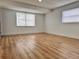 Bright and airy bedroom with wood-style flooring and large windows at 933 Windsor St, Lakeland, FL 33803