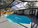 Inviting pool with a screened enclosure and a paved patio area at 933 Windsor St, Lakeland, FL 33803