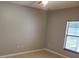 Bedroom with neutral walls, tile floors, and window at 123 Spoonbill Ct, Poinciana, FL 34759