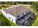 Backyard and roofline of the townhouses with enclosed pool decks and green grass at 1396 Peaceful Nature Way # 1396, Clermont, FL 34714