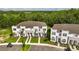 Modern townhouses with white and stone exteriors, surrounded by landscaping at 1396 Peaceful Nature Way # 1396, Clermont, FL 34714