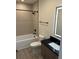 Modern bathroom with black fixtures, light wood vanity, and a tiled floor at 1396 Peaceful Nature Way # 1396, Clermont, FL 34714