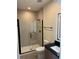 Modern bathroom with walk-in shower, black fixtures, and tiled walls at 1396 Peaceful Nature Way # 1396, Clermont, FL 34714