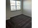Spacious bedroom with gray carpet and large window at 1396 Peaceful Nature Way # 1396, Clermont, FL 34714