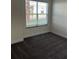 Empty bedroom with neutral walls, carpet, and a large window at 1396 Peaceful Nature Way # 1396, Clermont, FL 34714