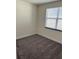 Empty bedroom with neutral walls and gray carpeting at 1396 Peaceful Nature Way # 1396, Clermont, FL 34714