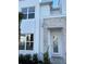 Close-up of a modern home's entrance with white door, gray stone accents, and landscaping at 1396 Peaceful Nature Way # 1396, Clermont, FL 34714