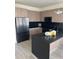 Contemporary kitchen boasting stainless steel appliances, black countertop, and ample storage at 1396 Peaceful Nature Way # 1396, Clermont, FL 34714