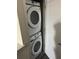Laundry room with a stacked washer and dryer at 1396 Peaceful Nature Way # 1396, Clermont, FL 34714