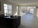 Spacious living room featuring tile flooring, large windows, and access to the pool area at 1396 Peaceful Nature Way # 1396, Clermont, FL 34714