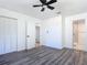 Spacious bedroom with dark wood-look floors, white walls, ceiling fan, and ensuite bathroom access at 1428 Margina Ave, Daytona Beach, FL 32114