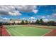 Community tennis courts with a clubhouse under blue skies at 1541 Clubhouse Blvd, Davenport, FL 33837