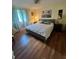 Main bedroom with king-size bed and wood floors at 1600 W Lake Parker Dr # B23, Lakeland, FL 33805