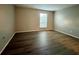 Spacious bedroom with wood-look flooring and large window at 200 Maitland Ave # 93, Altamonte Springs, FL 32701