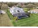 Modern home showcasing a screened pool and meticulously landscaped yard at 3167 Whisper Wind Dr, St Cloud, FL 34771