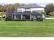 Two-story home with covered patio, pool, and lush green lawn at 3167 Whisper Wind Dr, St Cloud, FL 34771