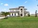 Two-story home with stone accents and a beautifully manicured lawn at 3167 Whisper Wind Dr, St Cloud, FL 34771