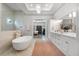 Spa-like bathroom with soaking tub, walk-in shower, and marble flooring at 3167 Whisper Wind Dr, St Cloud, FL 34771